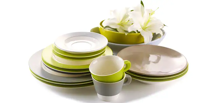 Colorful coastal dinnerware stacked with flowers, perfect for seaside home decor.