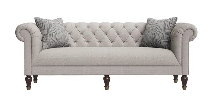 Luxurious beige tufted sofa with rolled arms and wooden legs, ideal for coastal living rooms.