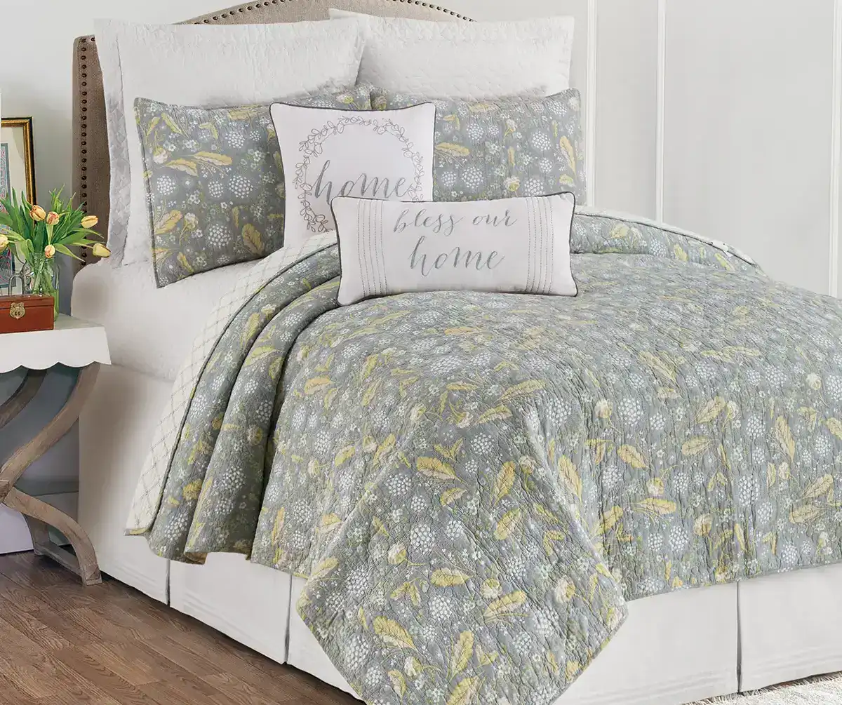 Soft coastal-themed bedding set with decorative pillows, perfect for a serene bedroom decor.